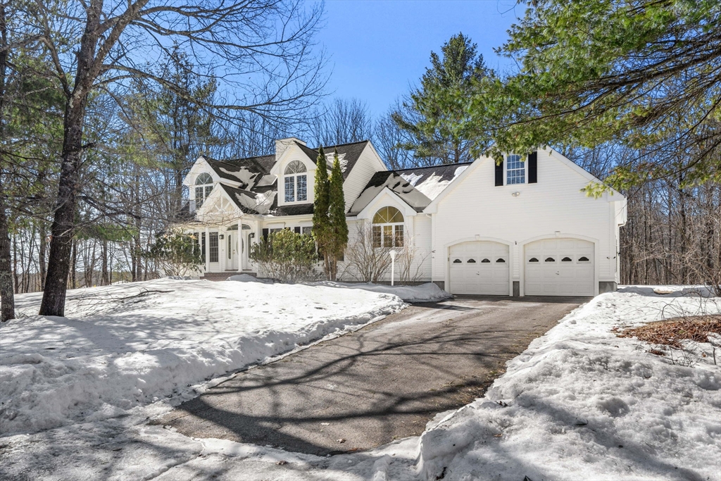 125 Adams Street Dunstable, MA 01827 - Photo 1 of 39 a view of a white house with a snow on the road