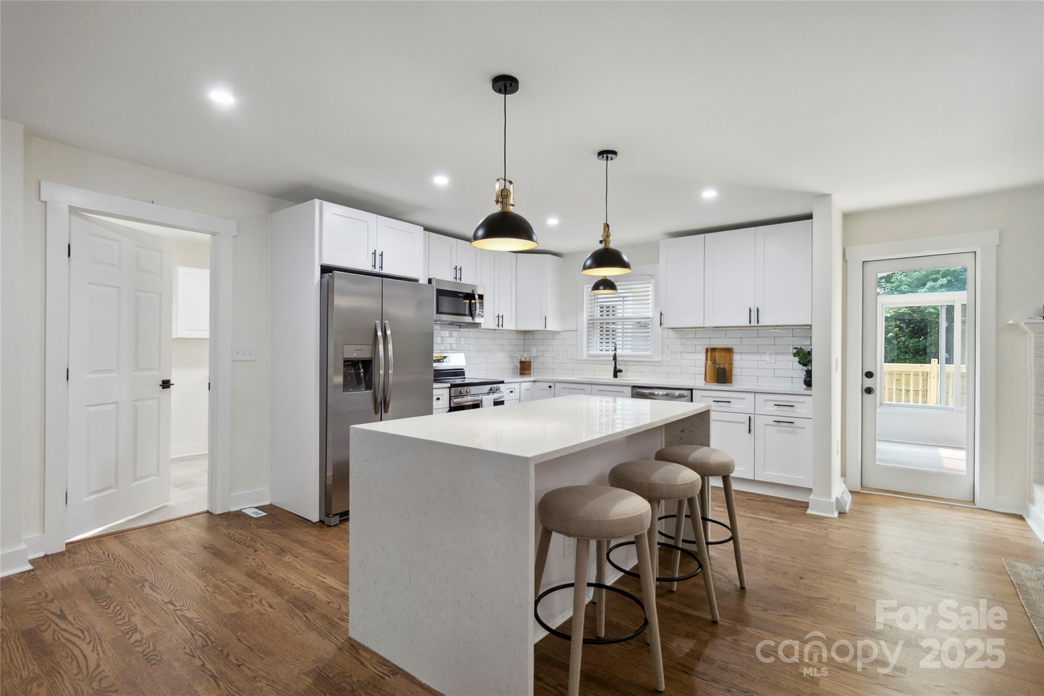 3801 Rea Road Charlotte, NC 28226 - Photo 13 of 47 a kitchen with stainless steel appliances a dining table chairs refrigerator and cabinets