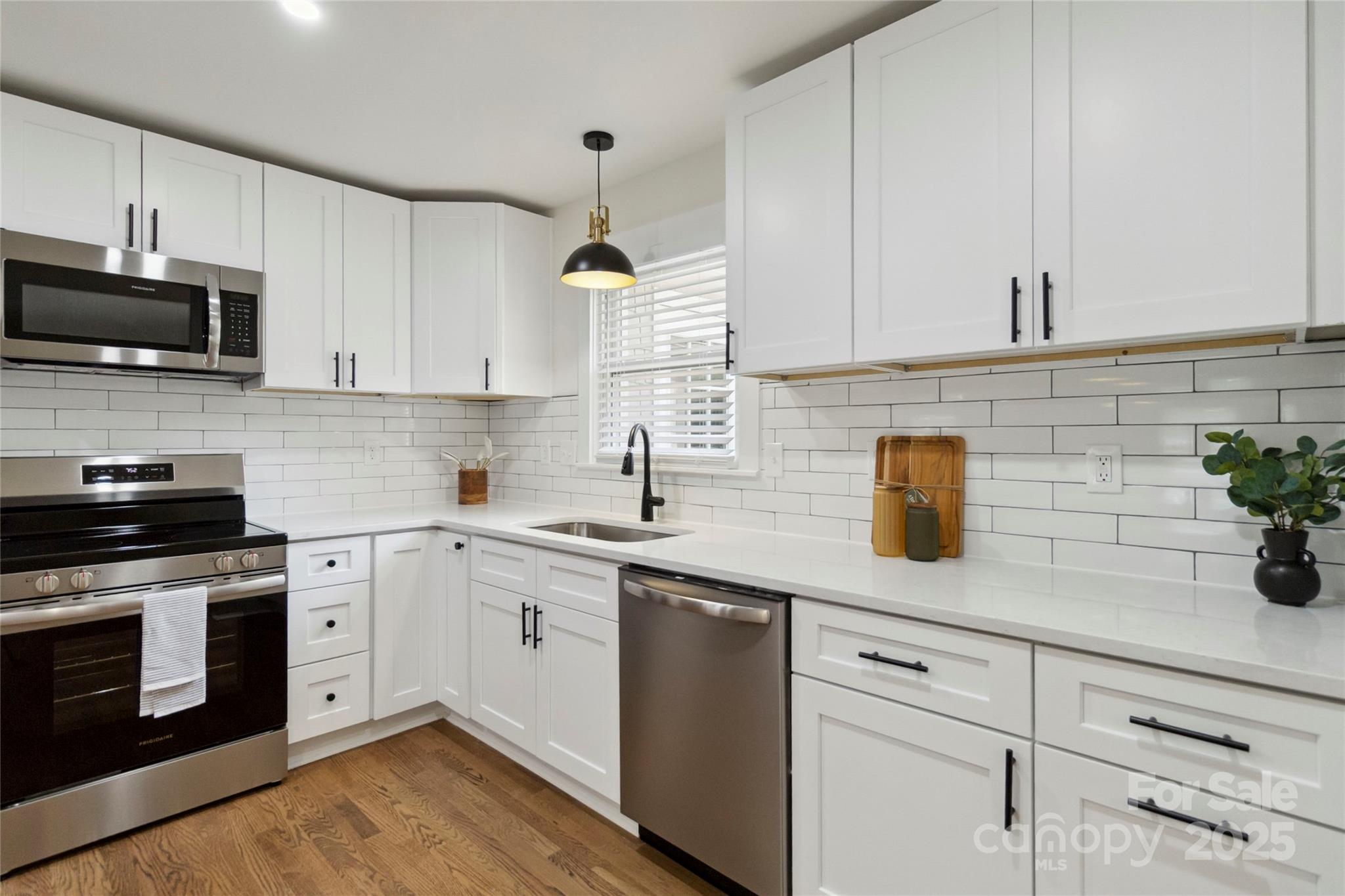 3801 Rea Road Charlotte, NC 28226 - Photo 14 of 47 a kitchen with granite countertop white cabinets stainless steel appliances and a potted plant
