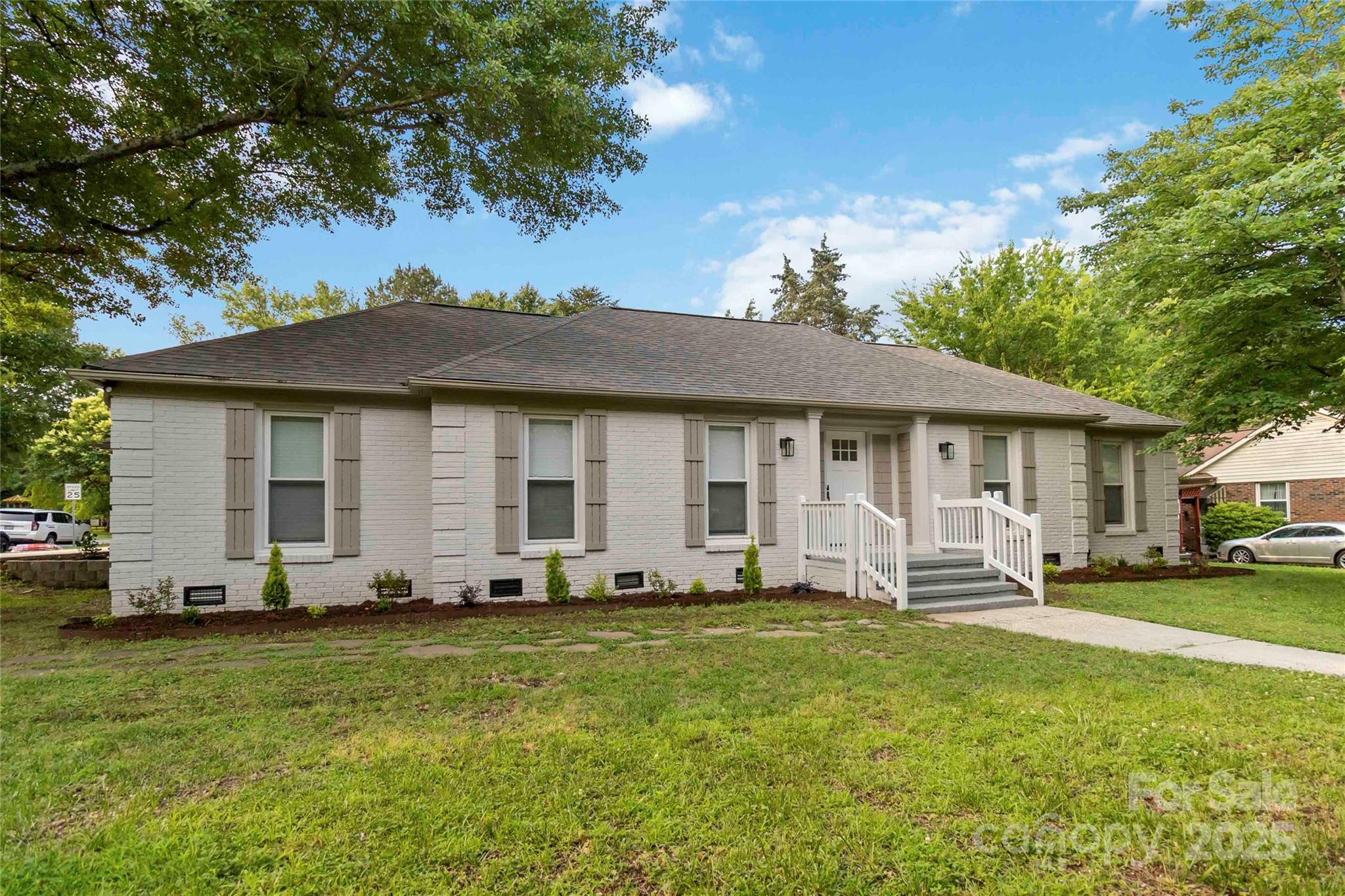 3801 Rea Road Charlotte, NC 28226 - Photo 2 of 47 a front view of a house with a garden and porch