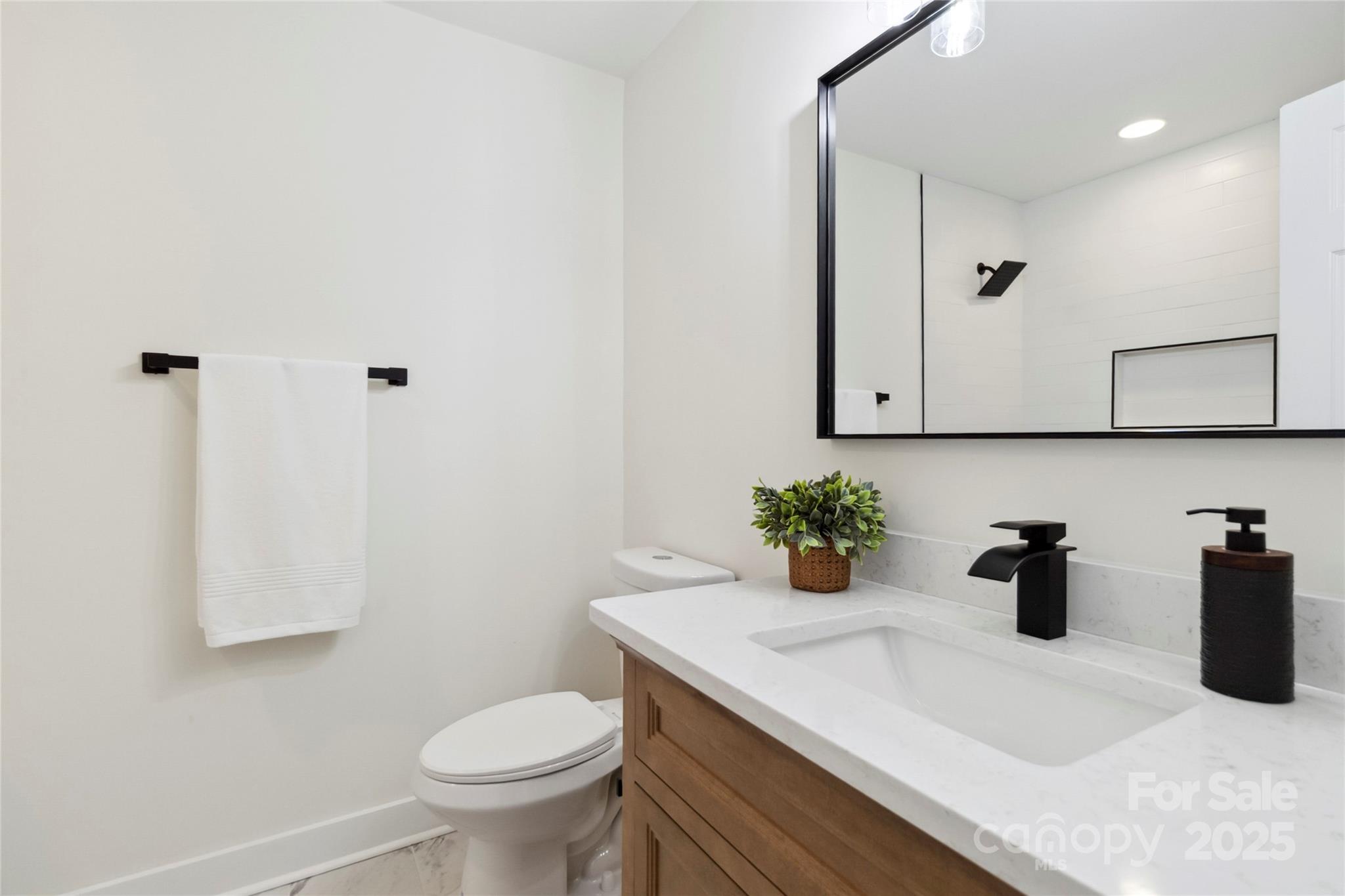 3801 Rea Road Charlotte, NC 28226 - Photo 25 of 47 a bathroom with a sink a toilet and mirror
