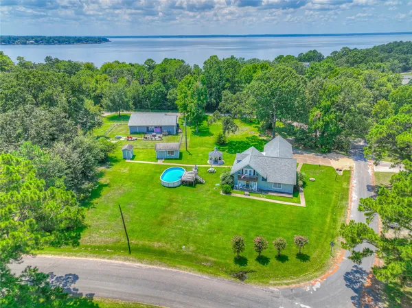 a view of a back yard of the house with a patio