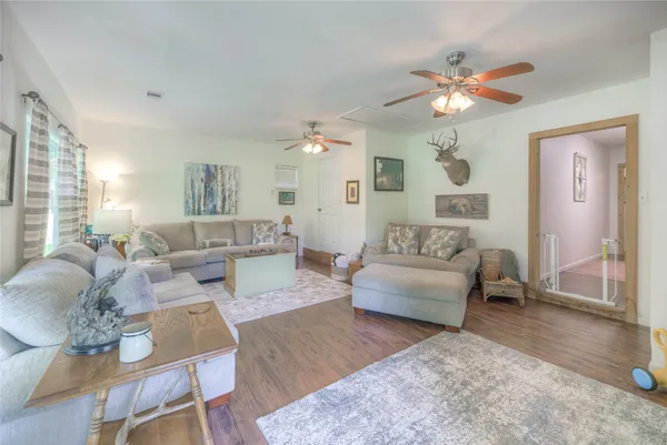a living room with furniture a flat screen tv and a large window