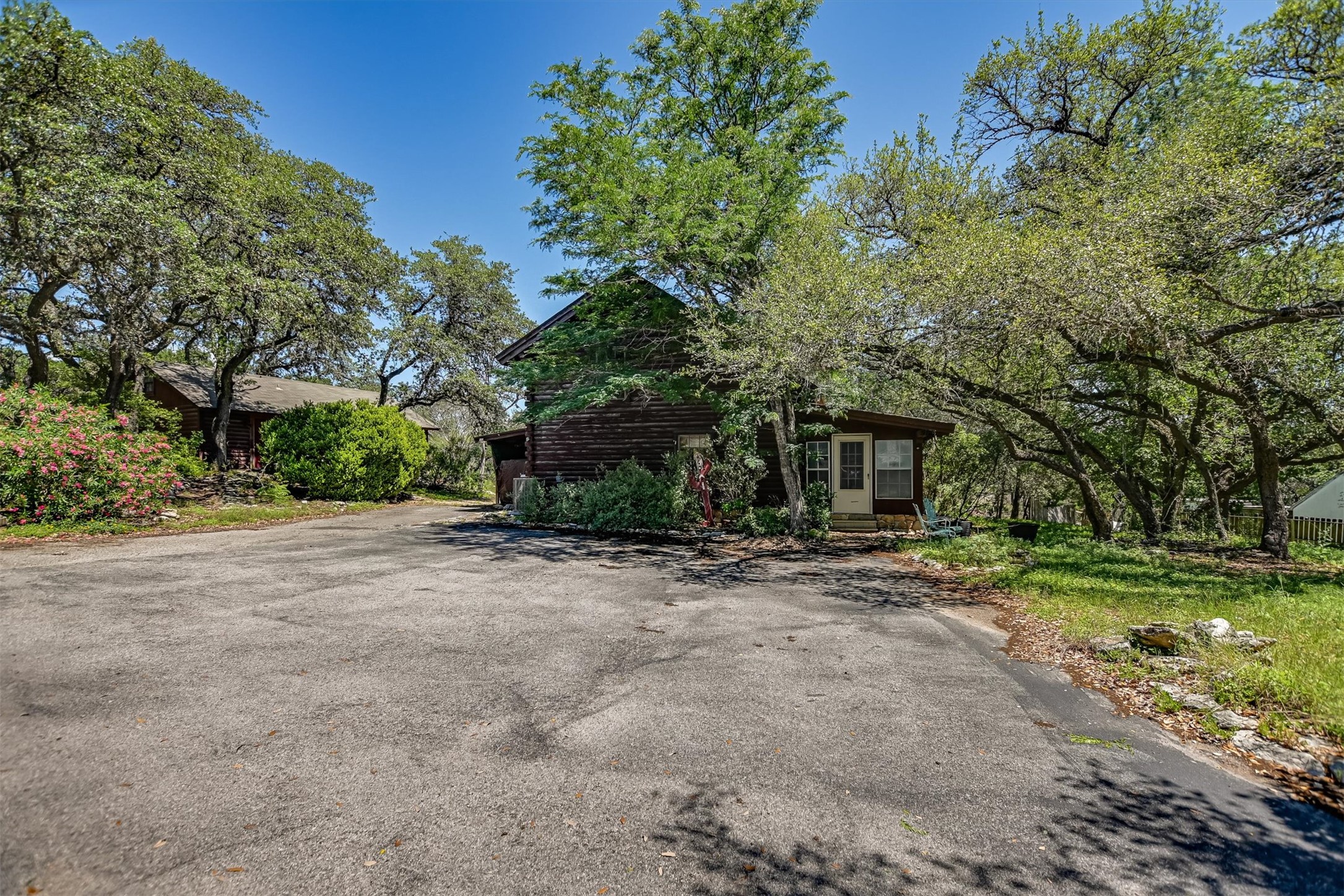 12711 Rr, Unit 12 Wimberley, TX 78676 - Photo 1 of 20 Both the main Wimberley log home and guest cottage are situated toward the rear of the nearly one-acre lot for added privacy