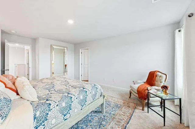 a bedroom with a bed and a chair