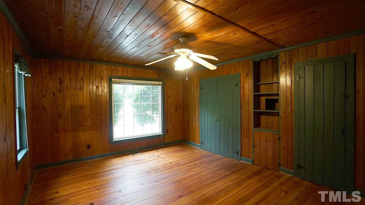 15109 Possum Track Road Raleigh, NC 27614 - Photo 22 of 27 a view of empty room with wooden floor and fan