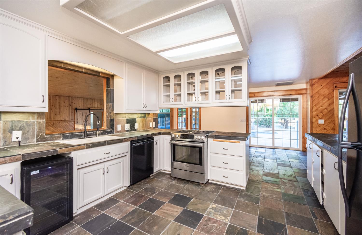 664 Perkins Road Arbuckle, CA 95912 - Photo 19 of 91 a kitchen with a stove sink and microwave