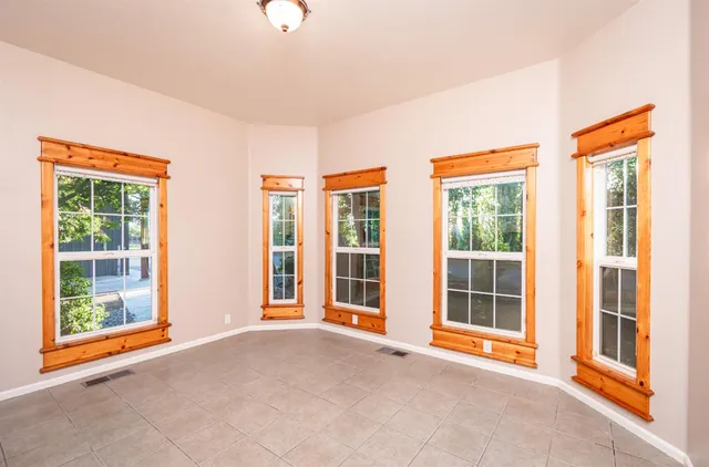 a view of a room with wooden floor