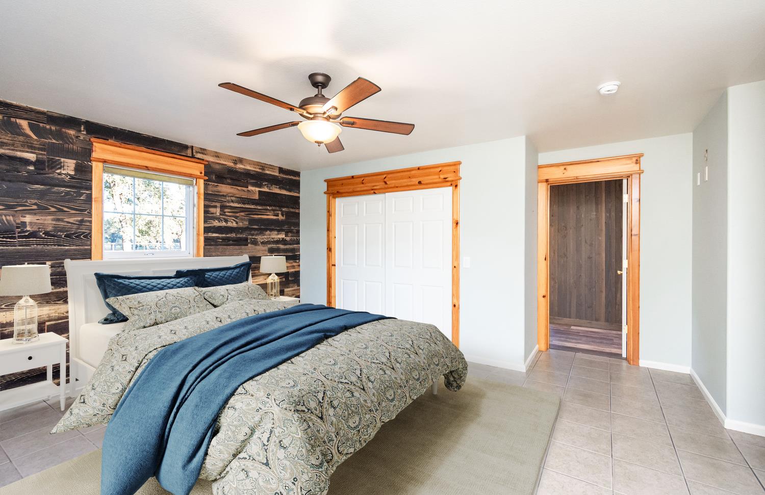 664 Perkins Road Arbuckle, CA 95912 - Photo 39 of 91 a bedroom with a large bed and a chandelier