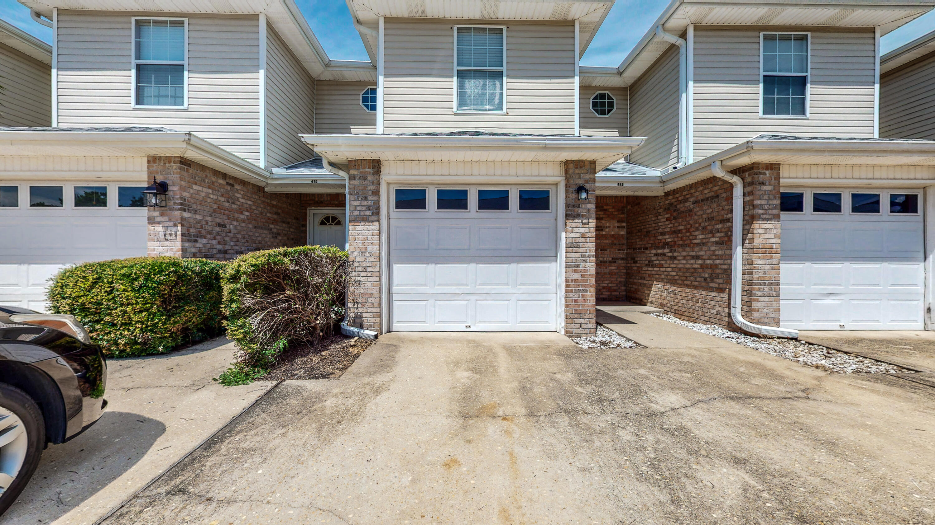 a view of a house with a yard and garage