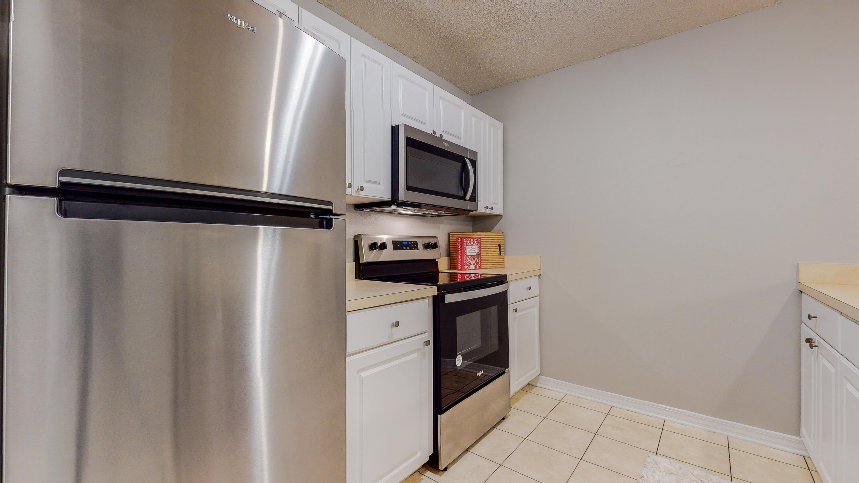 472 Keystone Road Mary Esther, FL 32569 - Photo 2 of 26 a kitchen with stainless steel appliances a refrigerator stove and microwave
