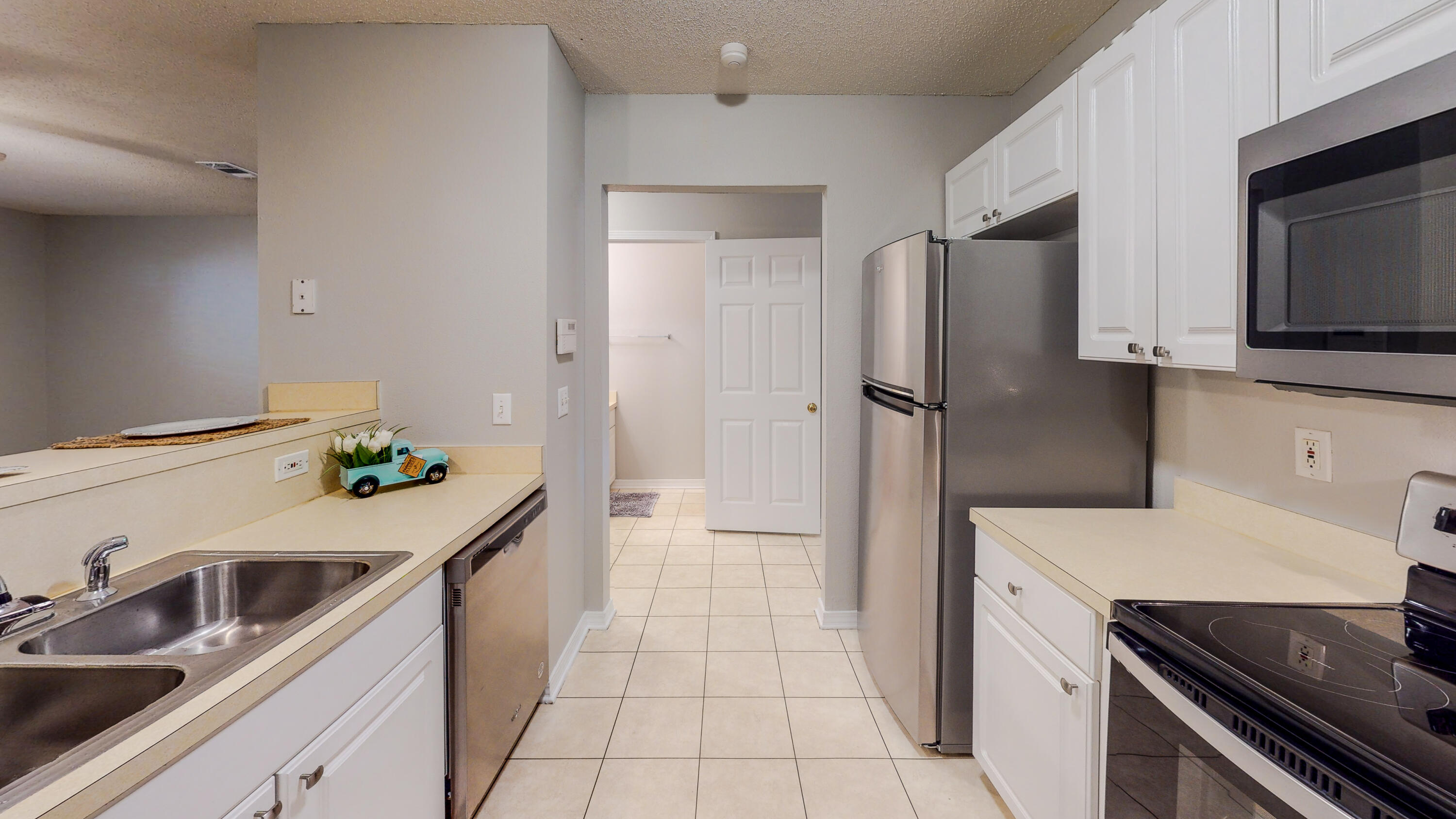 472 Keystone Road Mary Esther, FL 32569 - Photo 9 of 26 a kitchen with a sink stove and refrigerator