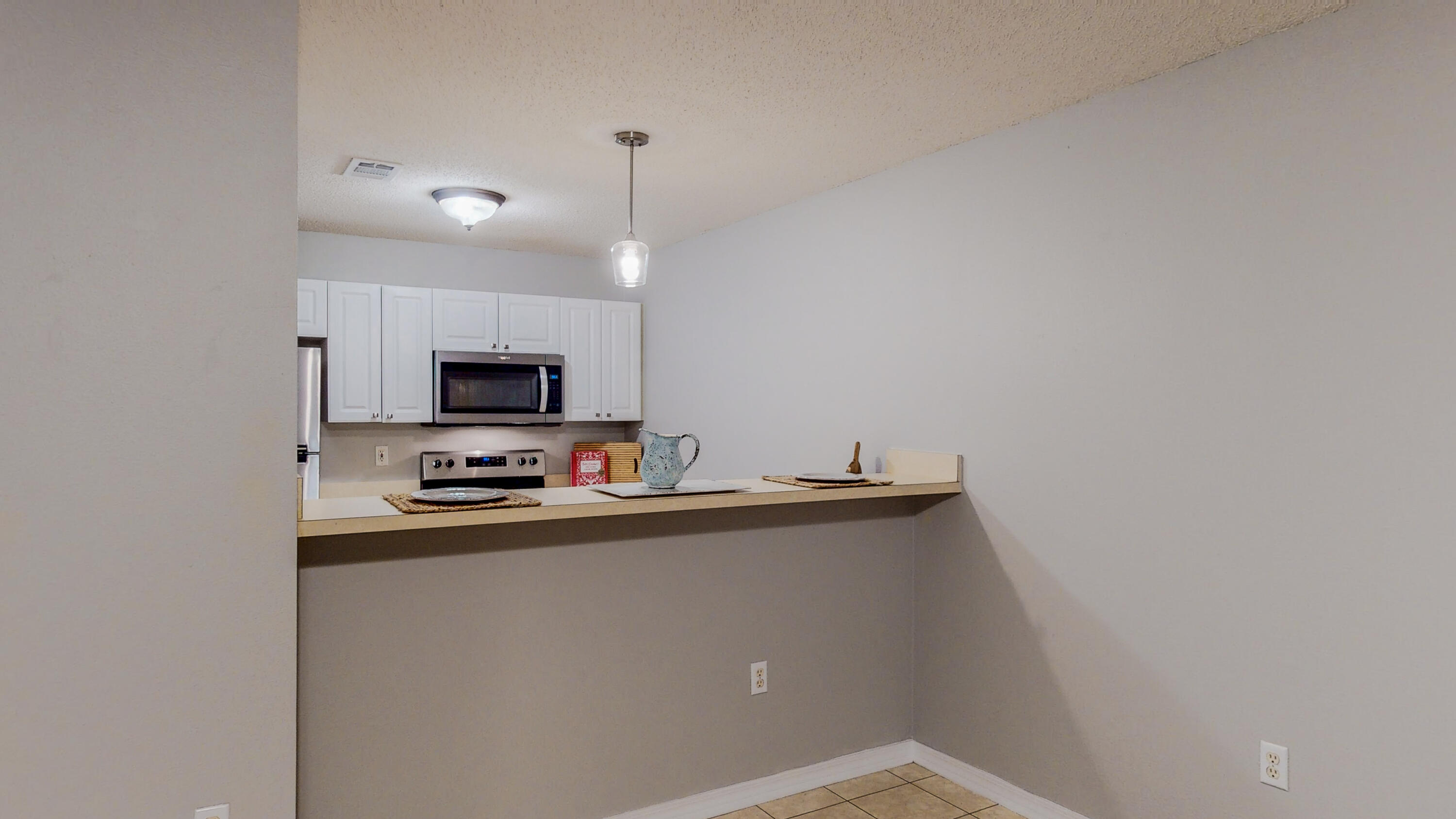 472 Keystone Road Mary Esther, FL 32569 - Photo 10 of 26 a kitchen with stainless steel appliances a refrigerator and a stove top oven
