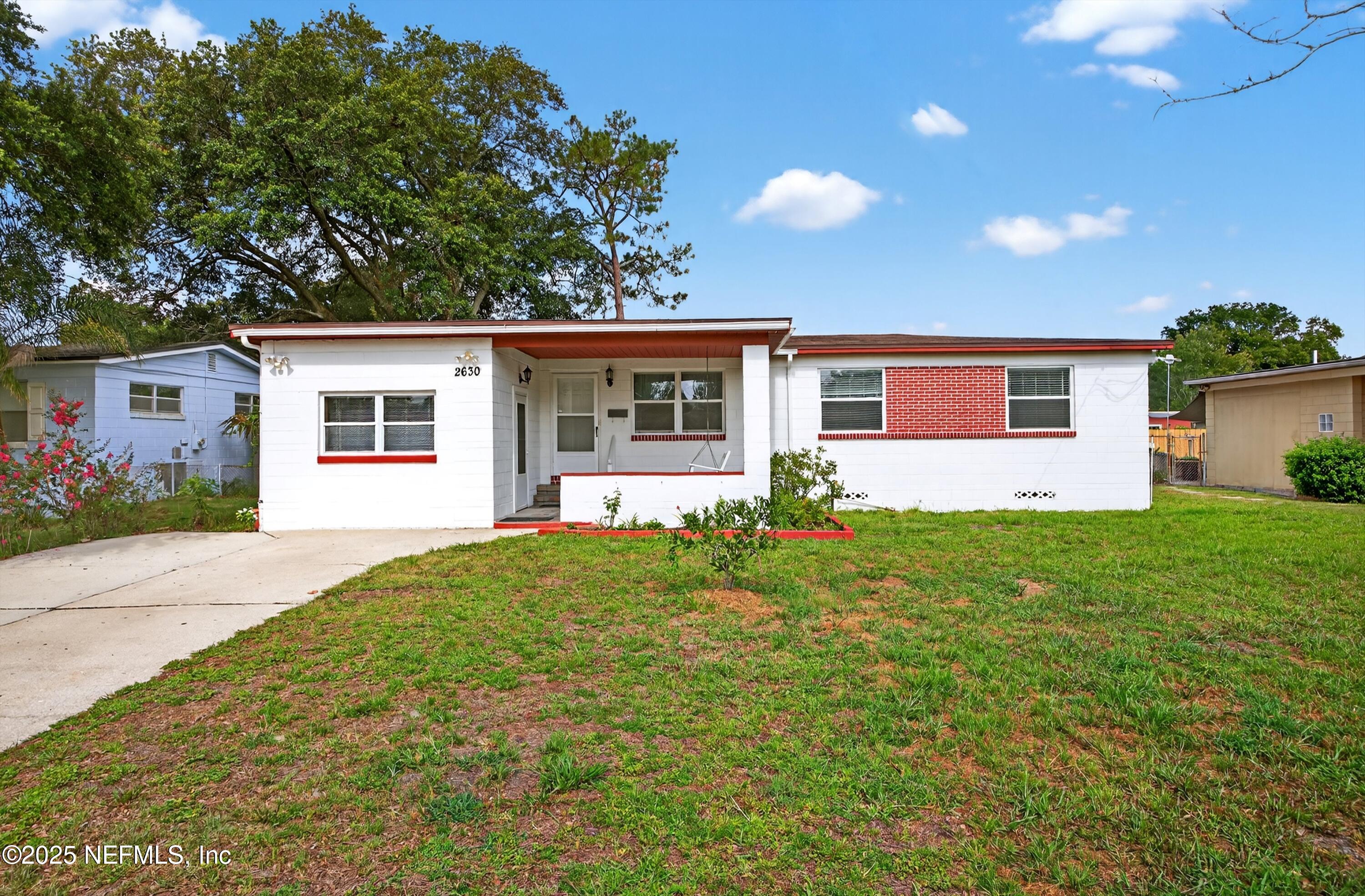 a front view of house with yard and green space