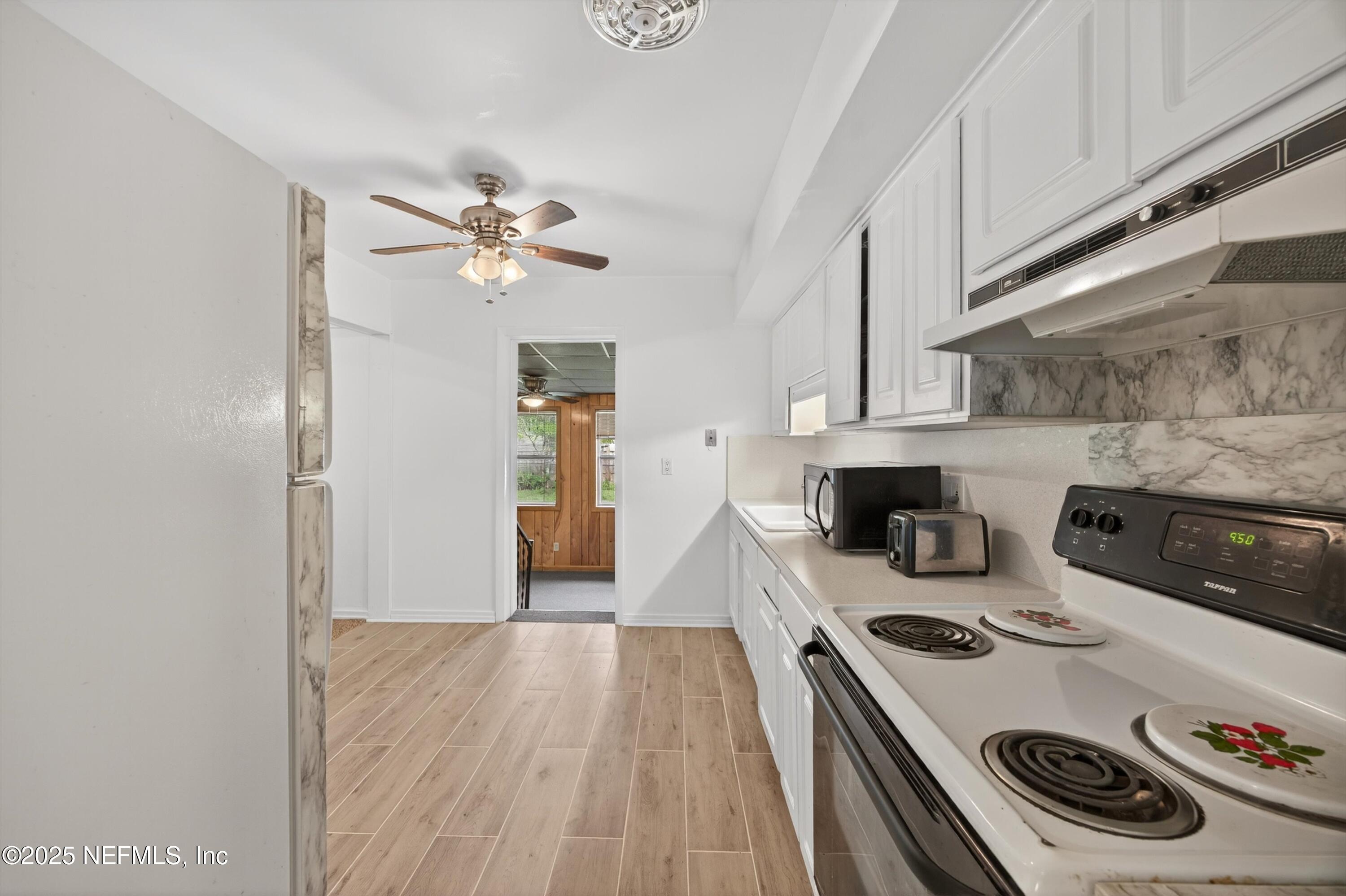 2630 Bywood Road Jacksonville, FL 32211 - Photo 12 of 35 a kitchen with a stove and wooden floor