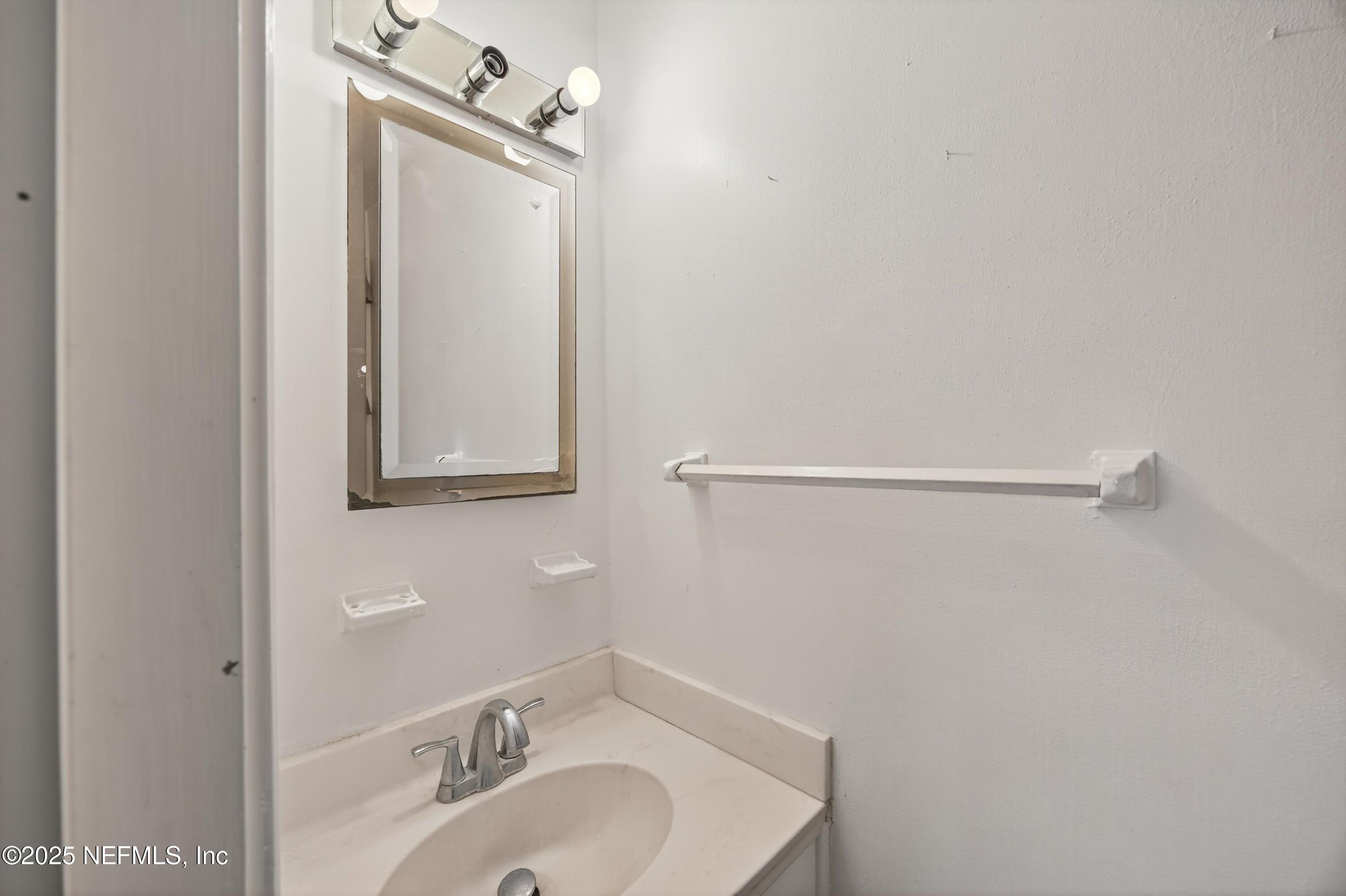 2630 Bywood Road Jacksonville, FL 32211 - Photo 26 of 35 a bathroom with a sink a mirror and vanity