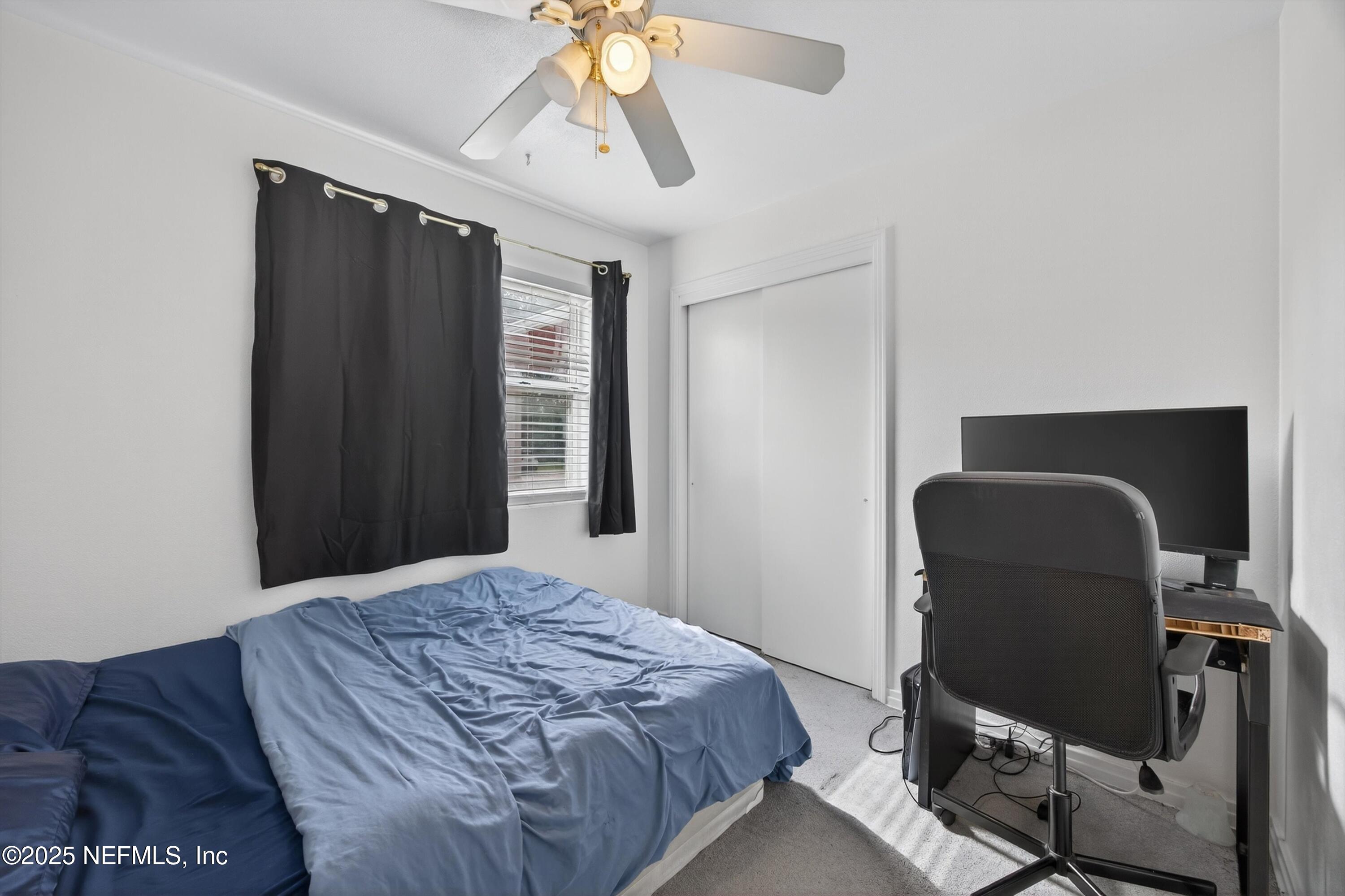 2630 Bywood Road Jacksonville, FL 32211 - Photo 27 of 35 a bedroom with a bed and cabinets