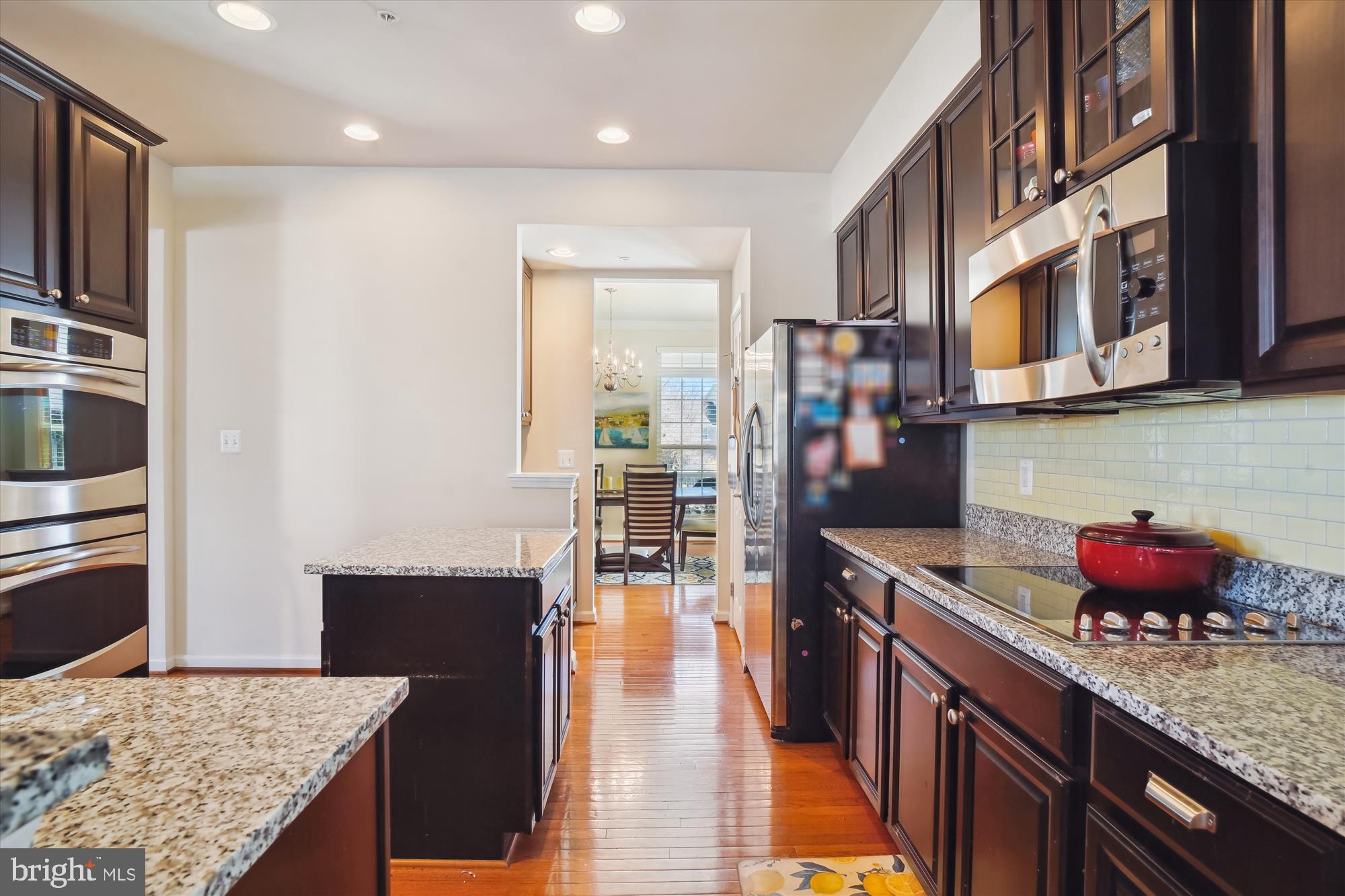 11903 Deer Spring Way Clarksburg, MD 20871 - Photo 15 of 88 a kitchen with stainless steel appliances granite countertop a stove refrigerator and a dining table