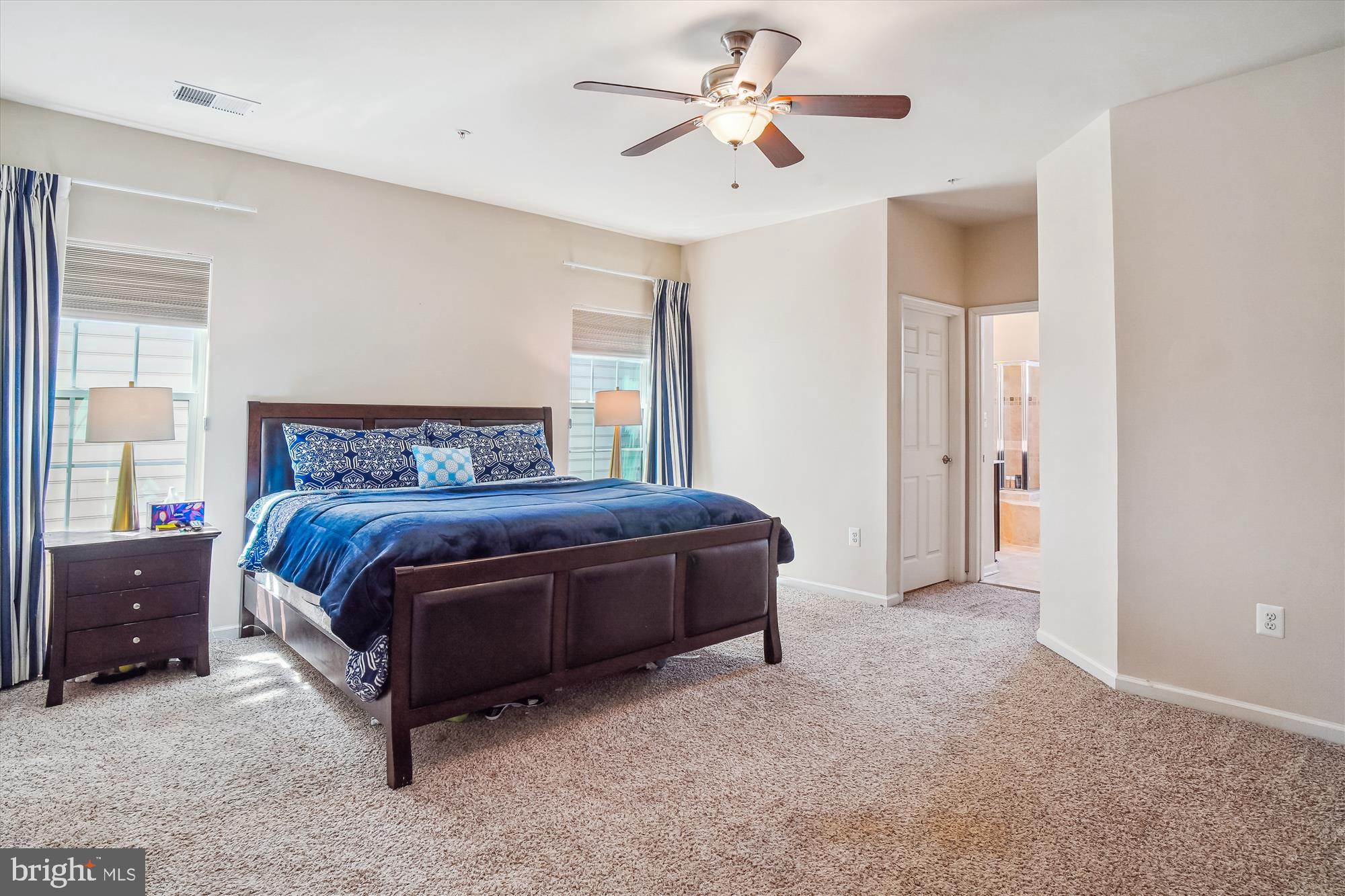 11903 Deer Spring Way Clarksburg, MD 20871 - Photo 27 of 88 a bedroom with a large bed and a chandelier