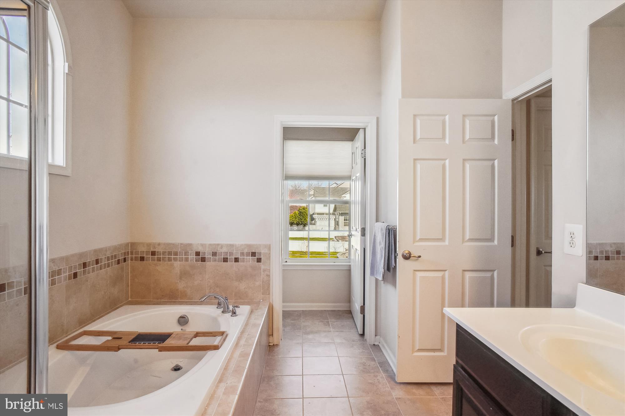 11903 Deer Spring Way Clarksburg, MD 20871 - Photo 30 of 88 a bathroom with a tub a sink and a window