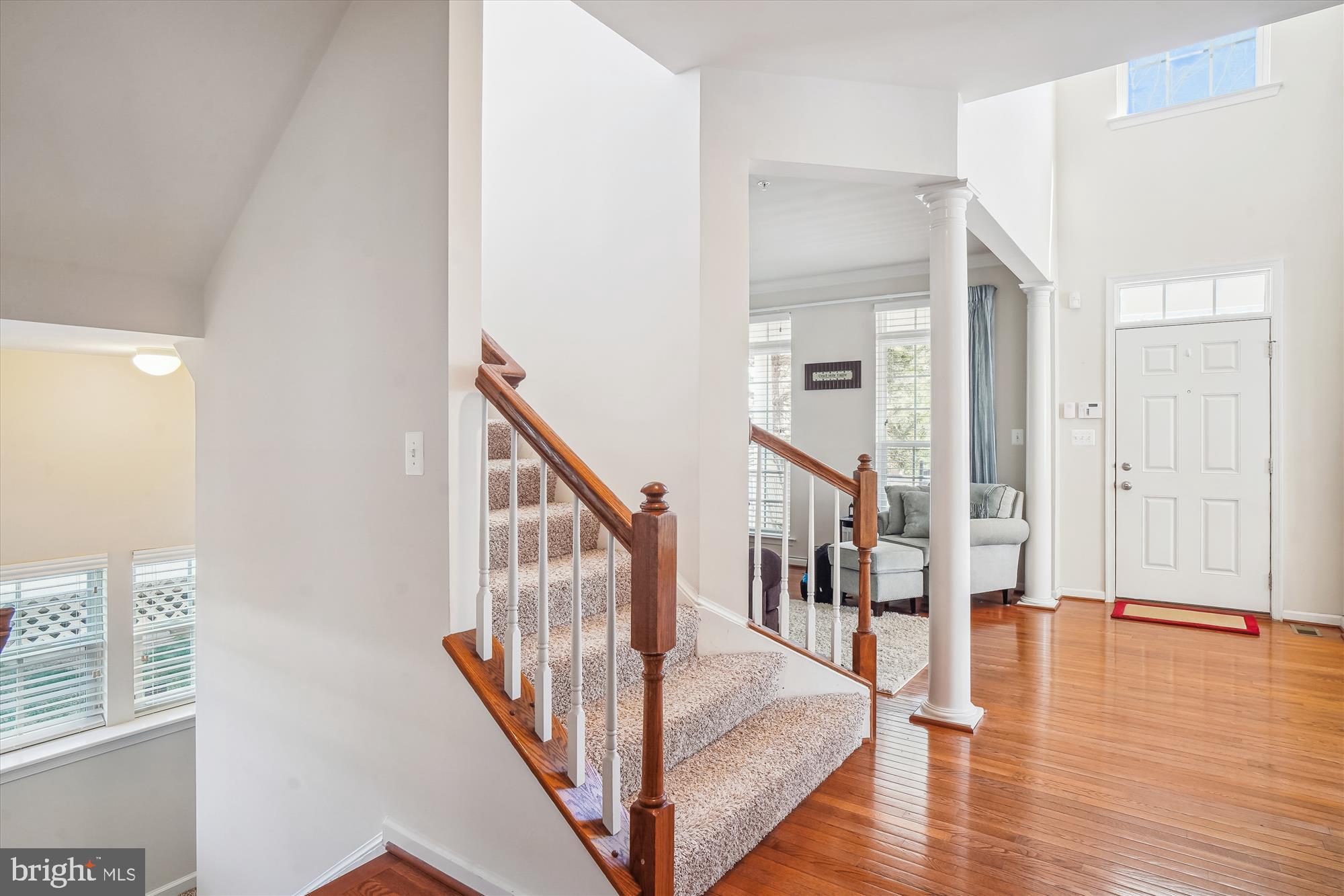 11903 Deer Spring Way Clarksburg, MD 20871 - Photo 42 of 88 a view of a hallway with wooden floor and staircase