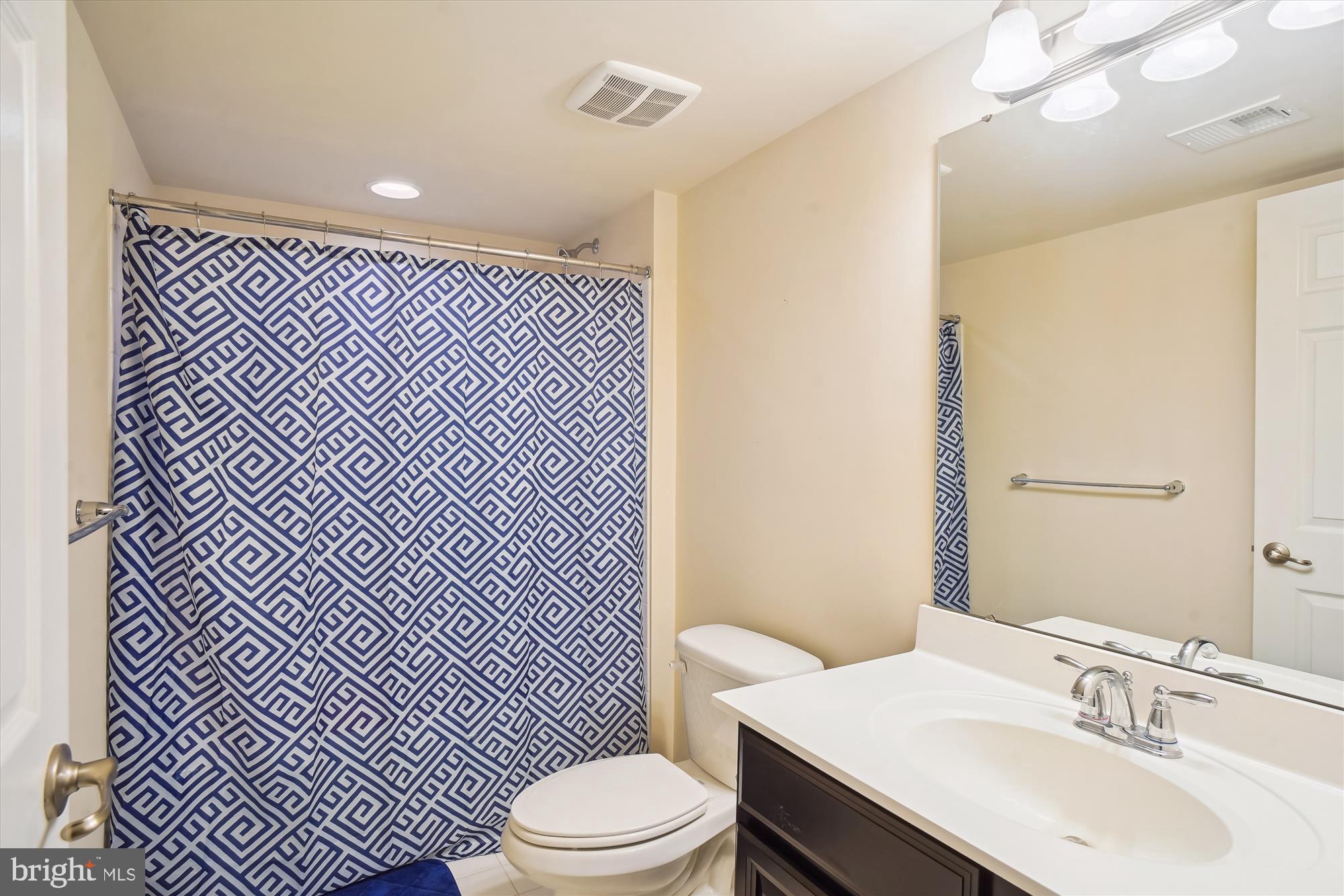 11903 Deer Spring Way Clarksburg, MD 20871 - Photo 45 of 88 a bathroom with a sink a toilet a mirror and shower
