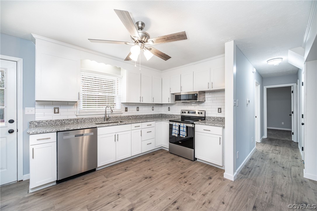 4741 Roxbury Road Charles City, VA 23030 - Photo 11 of 32 a kitchen with granite countertop a sink cabinets stainless steel appliances and a window