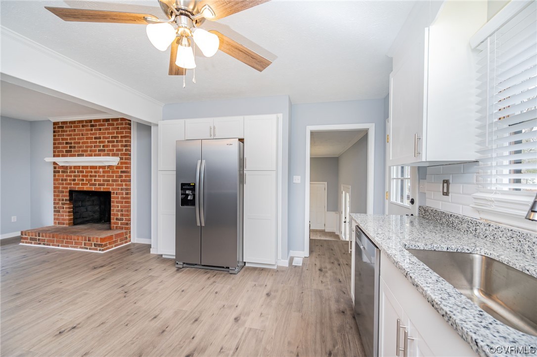 4741 Roxbury Road Charles City, VA 23030 - Photo 12 of 32 a kitchen with granite countertop a refrigerator a sink dishwasher and a stove with wooden floor