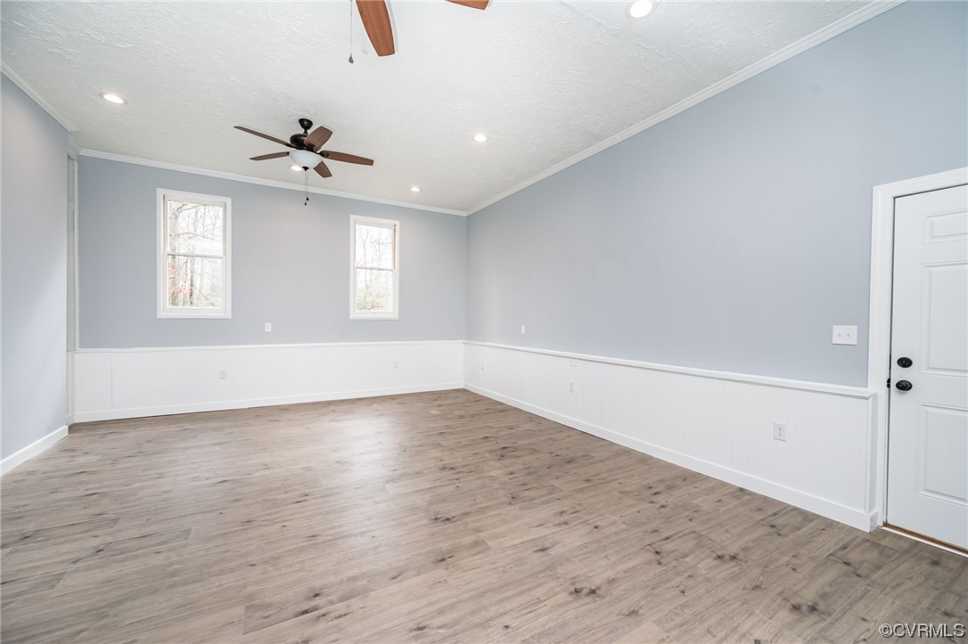 4741 Roxbury Road Charles City, VA 23030 - Photo 13 of 32 an empty room with wooden floor fan and windows