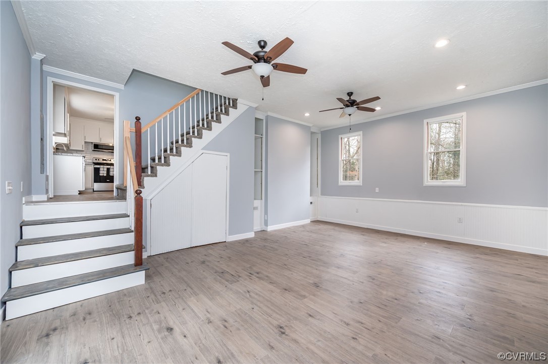 4741 Roxbury Road Charles City, VA 23030 - Photo 14 of 32 a view of a livingroom with wooden floor and a ceiling fan