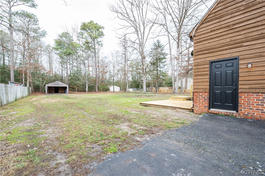 4741 Roxbury Road Charles City, VA 23030 - Photo 30 of 32 a view of a house with backyard and trees