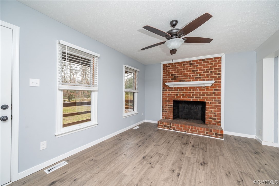 4741 Roxbury Road Charles City, VA 23030 - Photo 4 of 32 a view of an empty room with a fireplace and a window