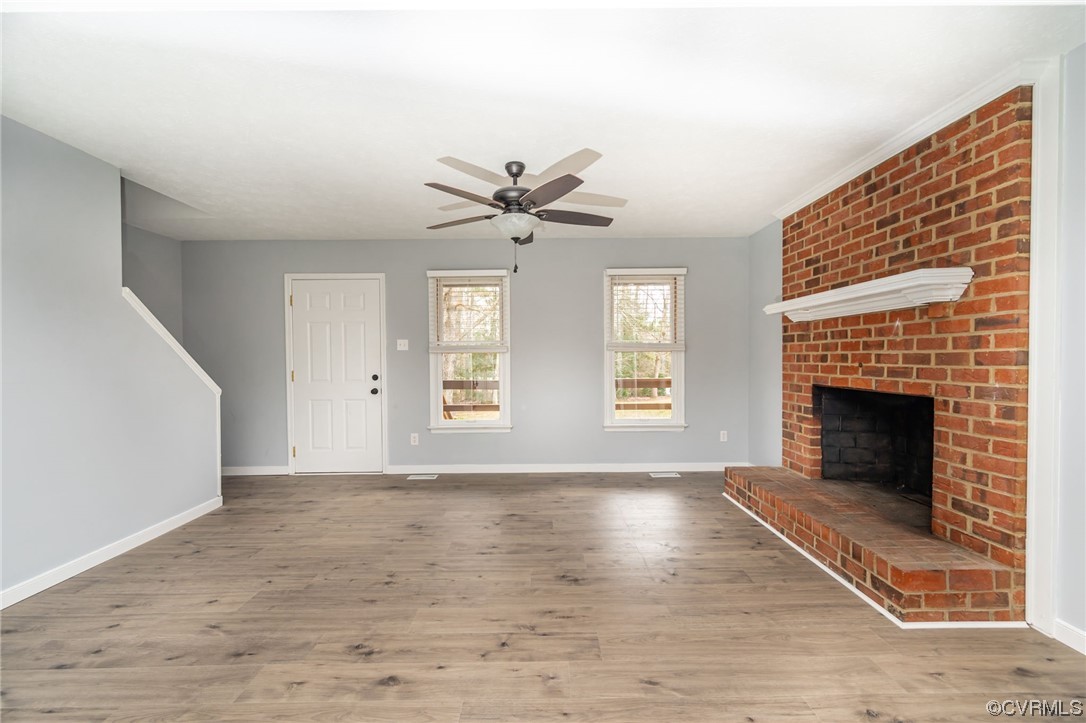 4741 Roxbury Road Charles City, VA 23030 - Photo 7 of 32 a view of an empty room with a fireplace and a window