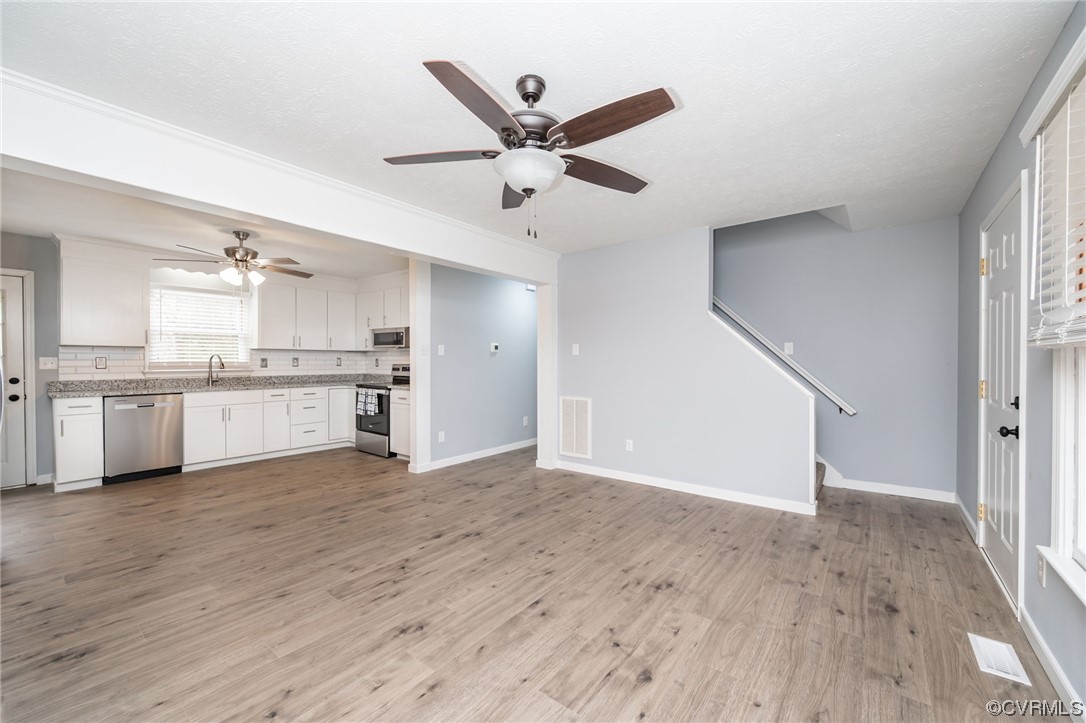 4741 Roxbury Road Charles City, VA 23030 - Photo 9 of 32 a view of a kitchen with wooden floor and a ceiling fan