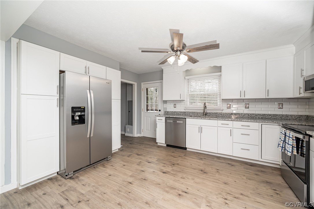 4741 Roxbury Road Charles City, VA 23030 - Photo 10 of 32 a large kitchen with cabinets stainless steel appliances and a window