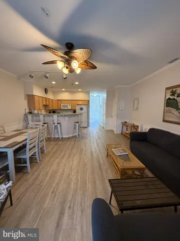 a living room with lots of furniture and kitchen view