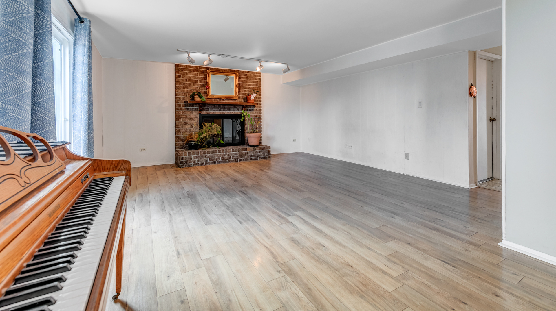 1651 West Goldengate Drive Addison, IL 60101 - Photo 12 of 24 an empty room with wooden floor fireplace and windows