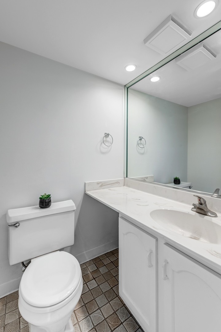 1651 West Goldengate Drive Addison, IL 60101 - Photo 13 of 24 a bathroom with a toilet sink and mirror