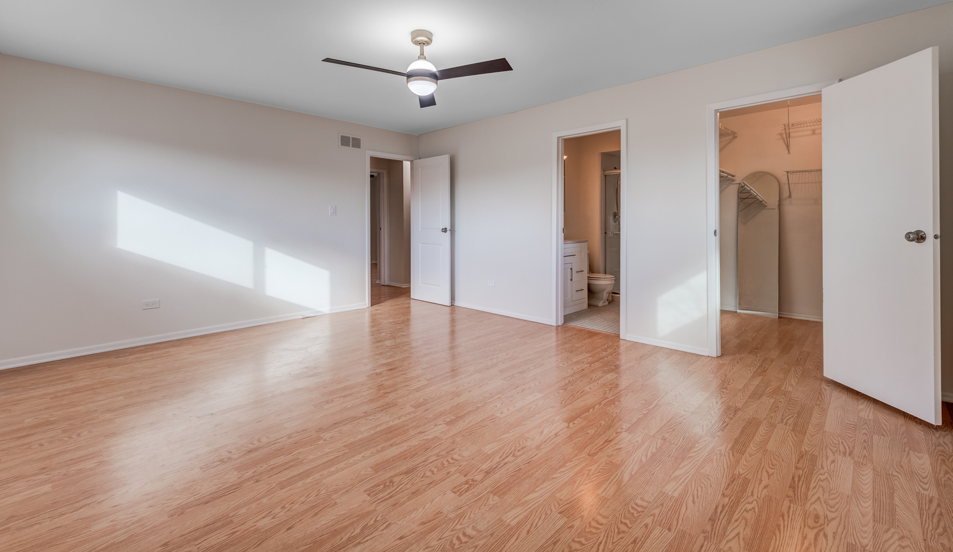 1651 West Goldengate Drive Addison, IL 60101 - Photo 14 of 24 a view of an empty room with wooden floor and a ceiling fan