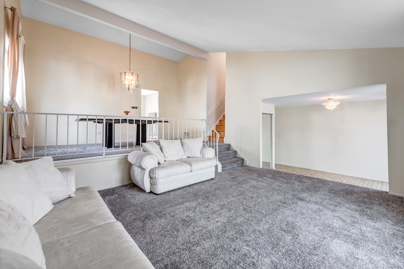 1651 West Goldengate Drive Addison, IL 60101 - Photo 3 of 24 a living room with furniture and a chandelier