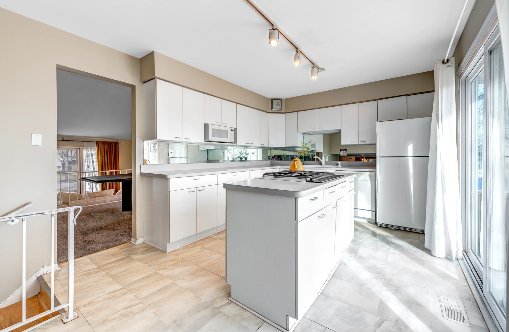 1651 West Goldengate Drive Addison, IL 60101 - Photo 7 of 24 a kitchen with white cabinets and white appliances