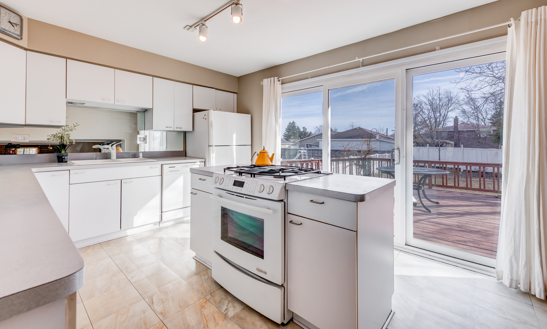 1651 West Goldengate Drive Addison, IL 60101 - Photo 8 of 24 a kitchen with a stove a sink and a refrigerator