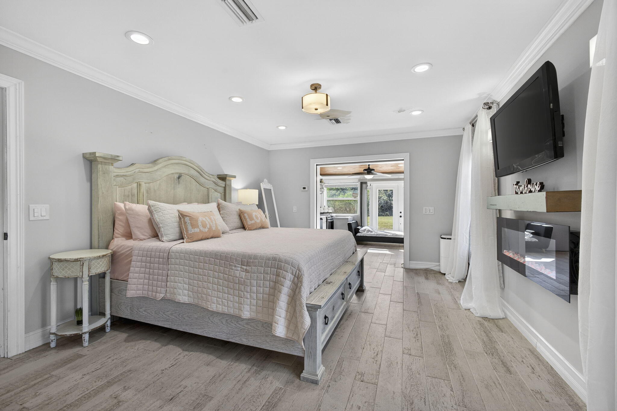 16490 Rustic Road Wellington, FL 33470 - Photo 16 of 81 a spacious bedroom with a bed and a flat screen tv