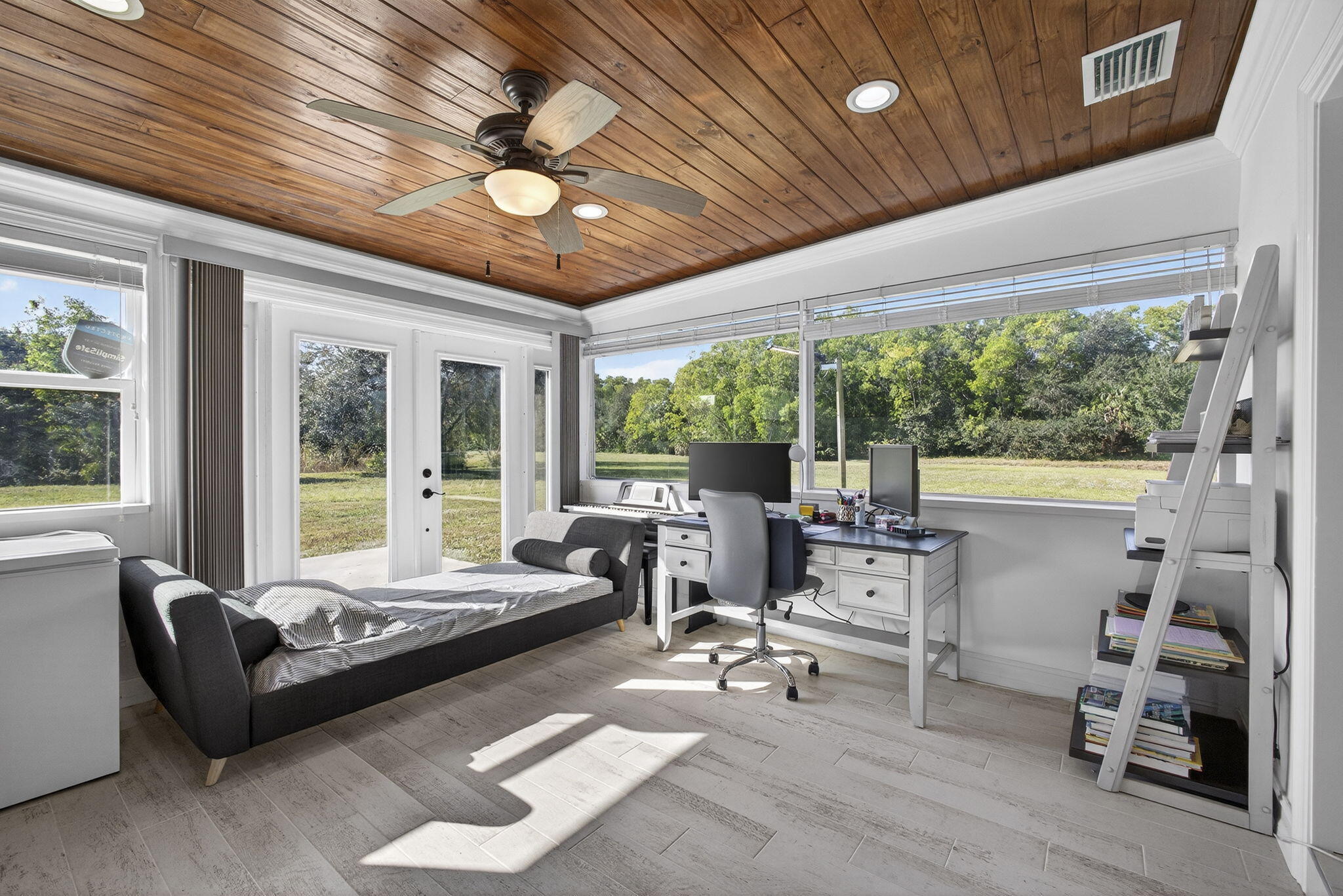 16490 Rustic Road Wellington, FL 33470 - Photo 19 of 81 a living room with furniture and large windows