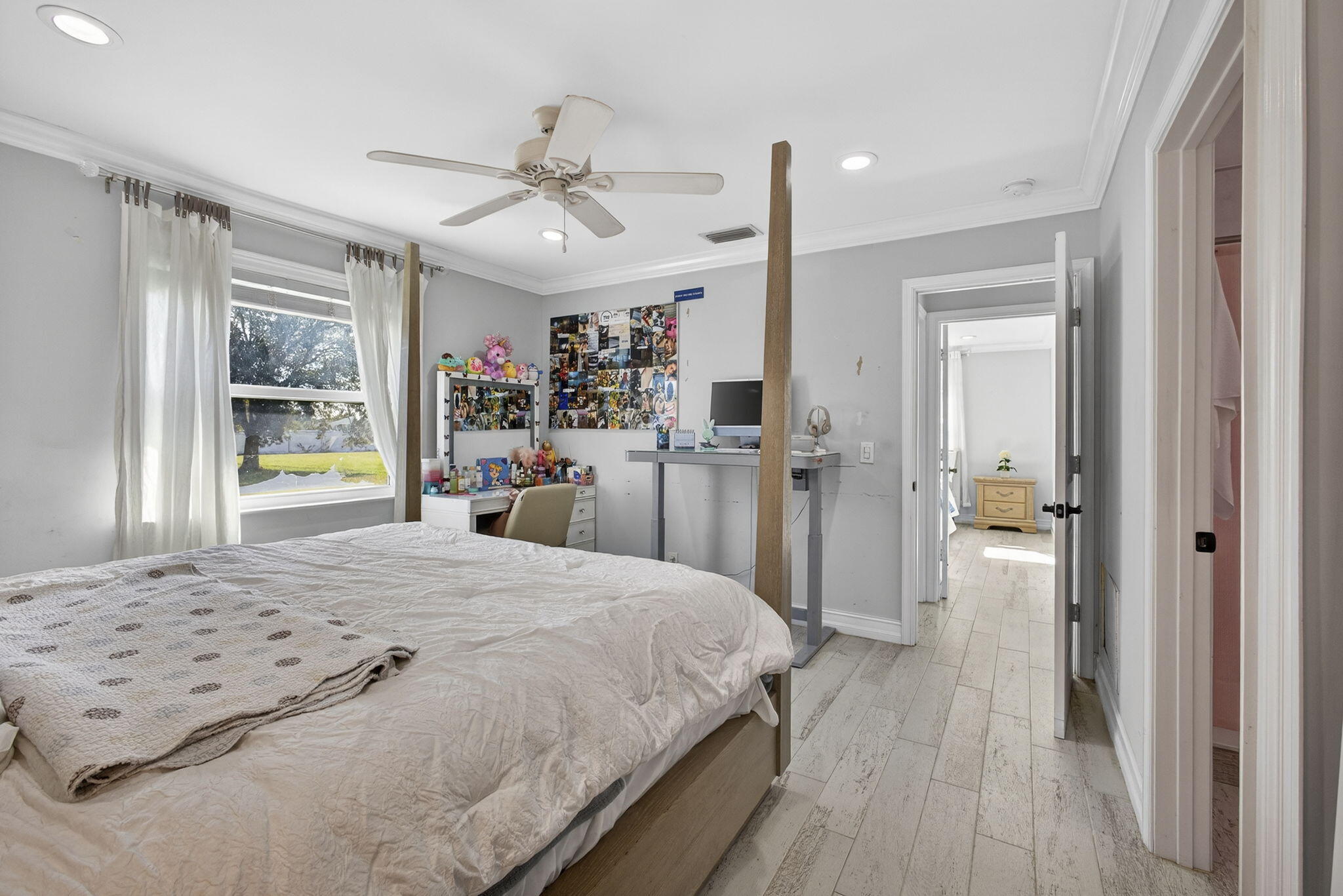 16490 Rustic Road Wellington, FL 33470 - Photo 29 of 81 a bedroom with a large bed and a chandelier