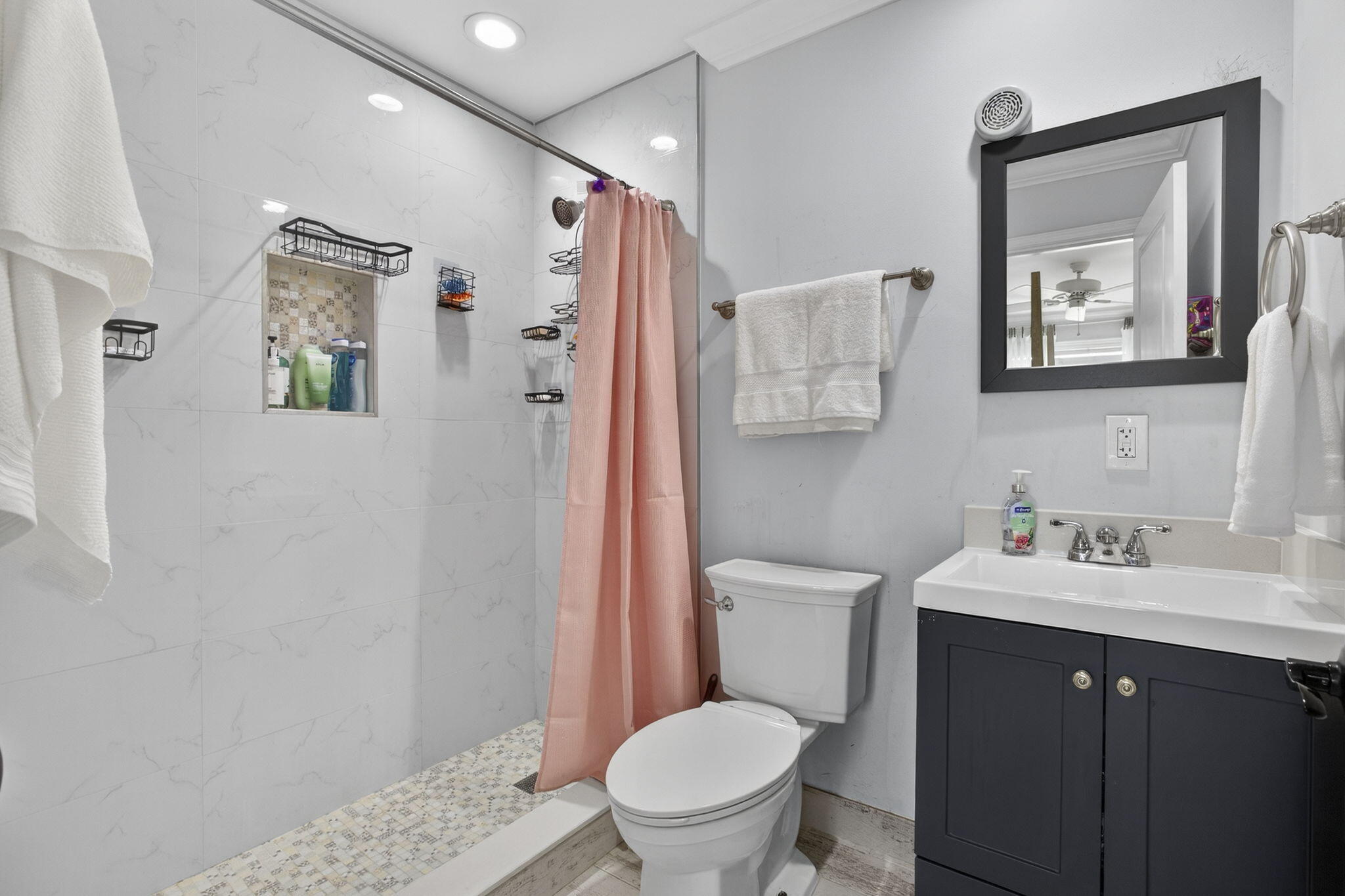 16490 Rustic Road Wellington, FL 33470 - Photo 30 of 81 a bathroom with a toilet sink vanity and mirror