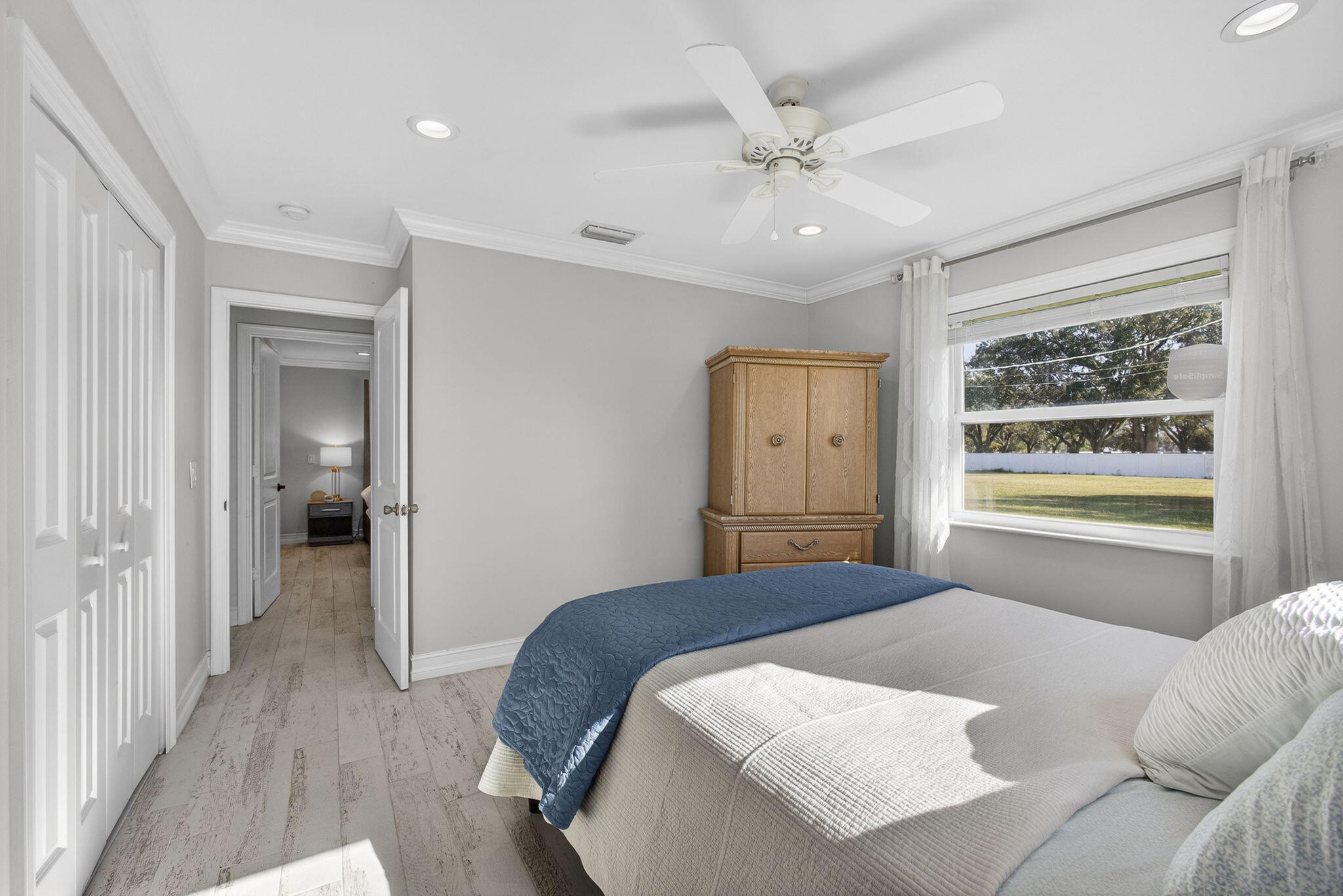 16490 Rustic Road Wellington, FL 33470 - Photo 35 of 81 a bedroom with a large bed and a chandelier