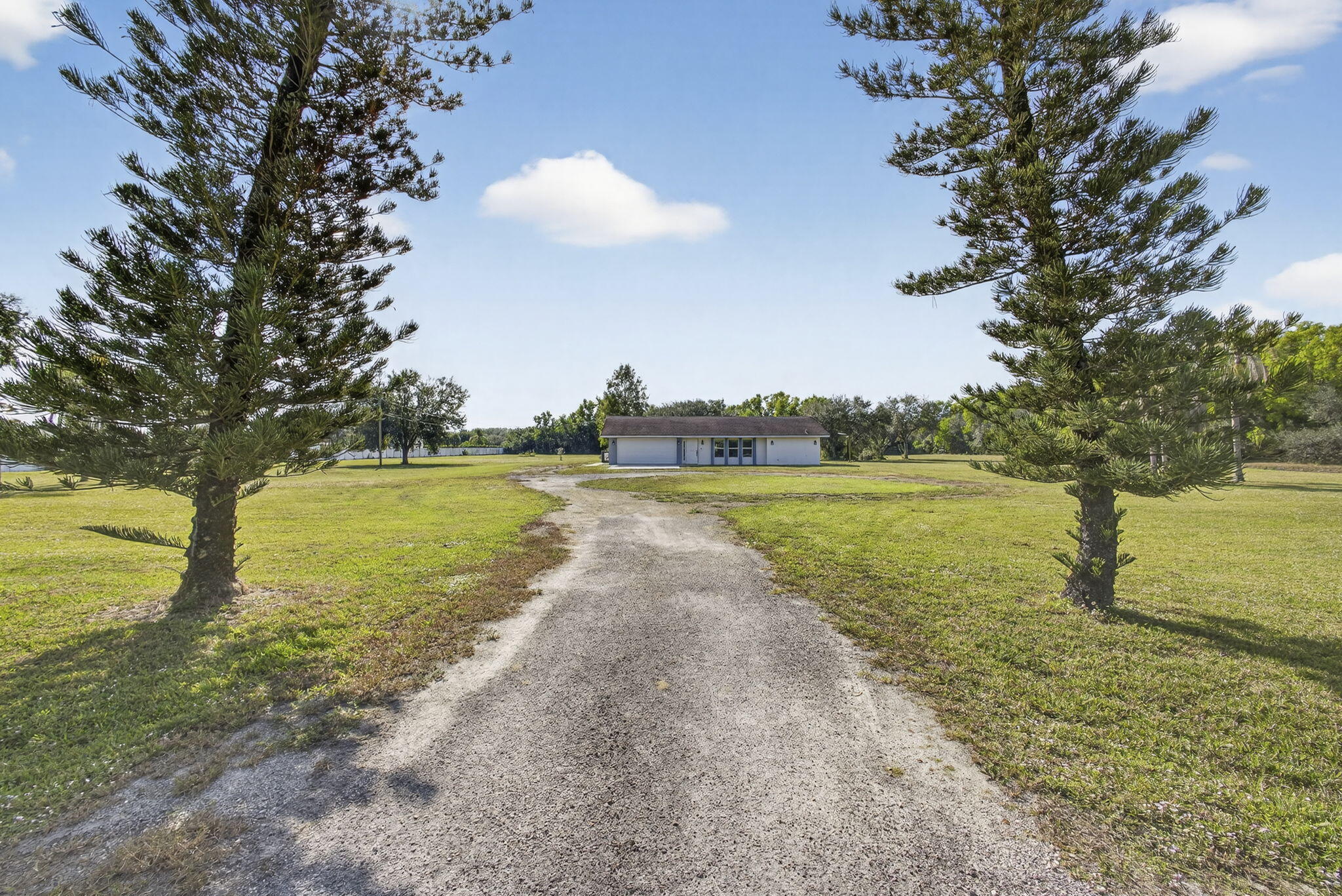16490 Rustic Road Wellington, FL 33470 - Photo 37 of 81 a view of a lake with a big yard and potted plants