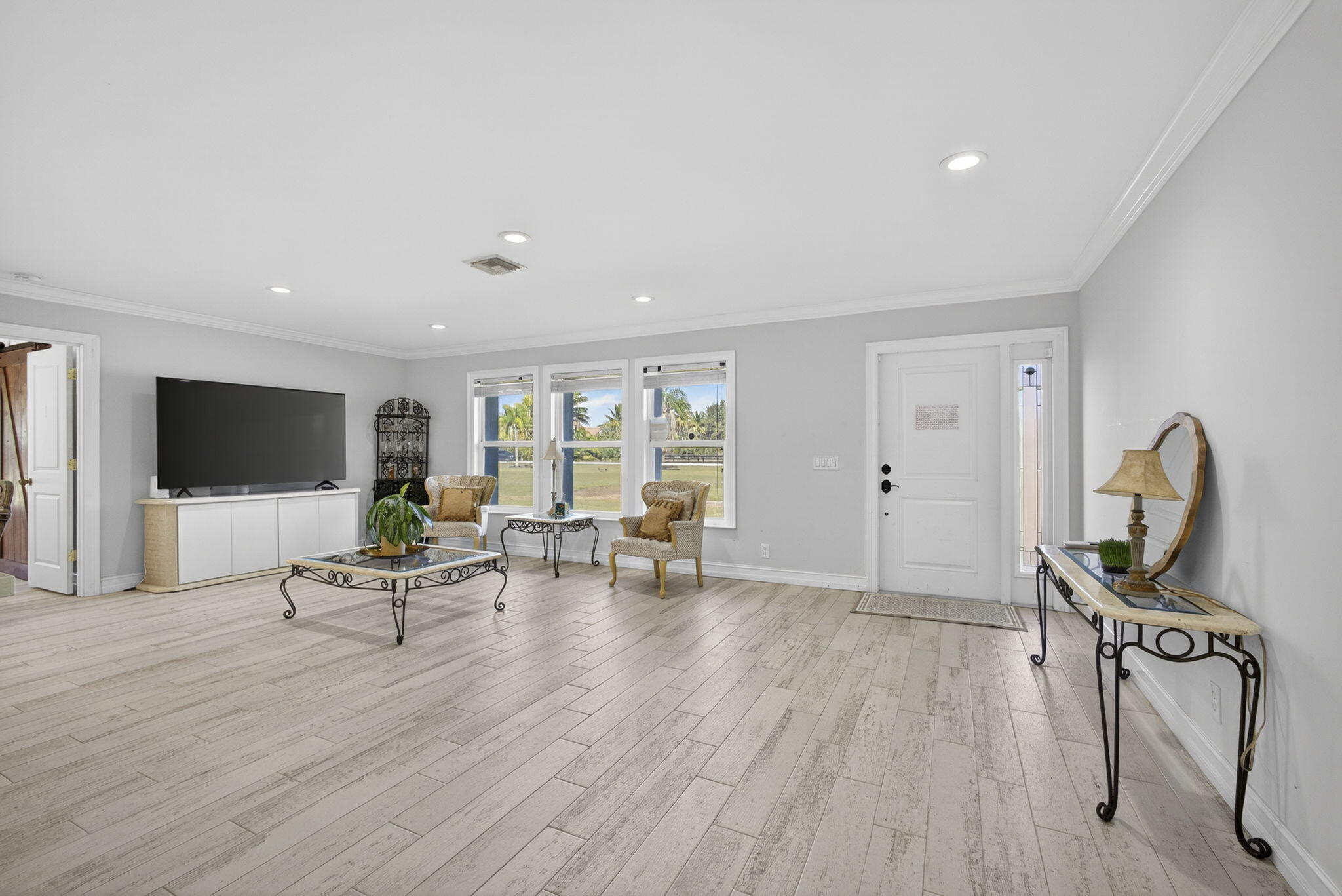 16490 Rustic Road Wellington, FL 33470 - Photo 4 of 81 a view of a livingroom with furniture and a flat screen tv