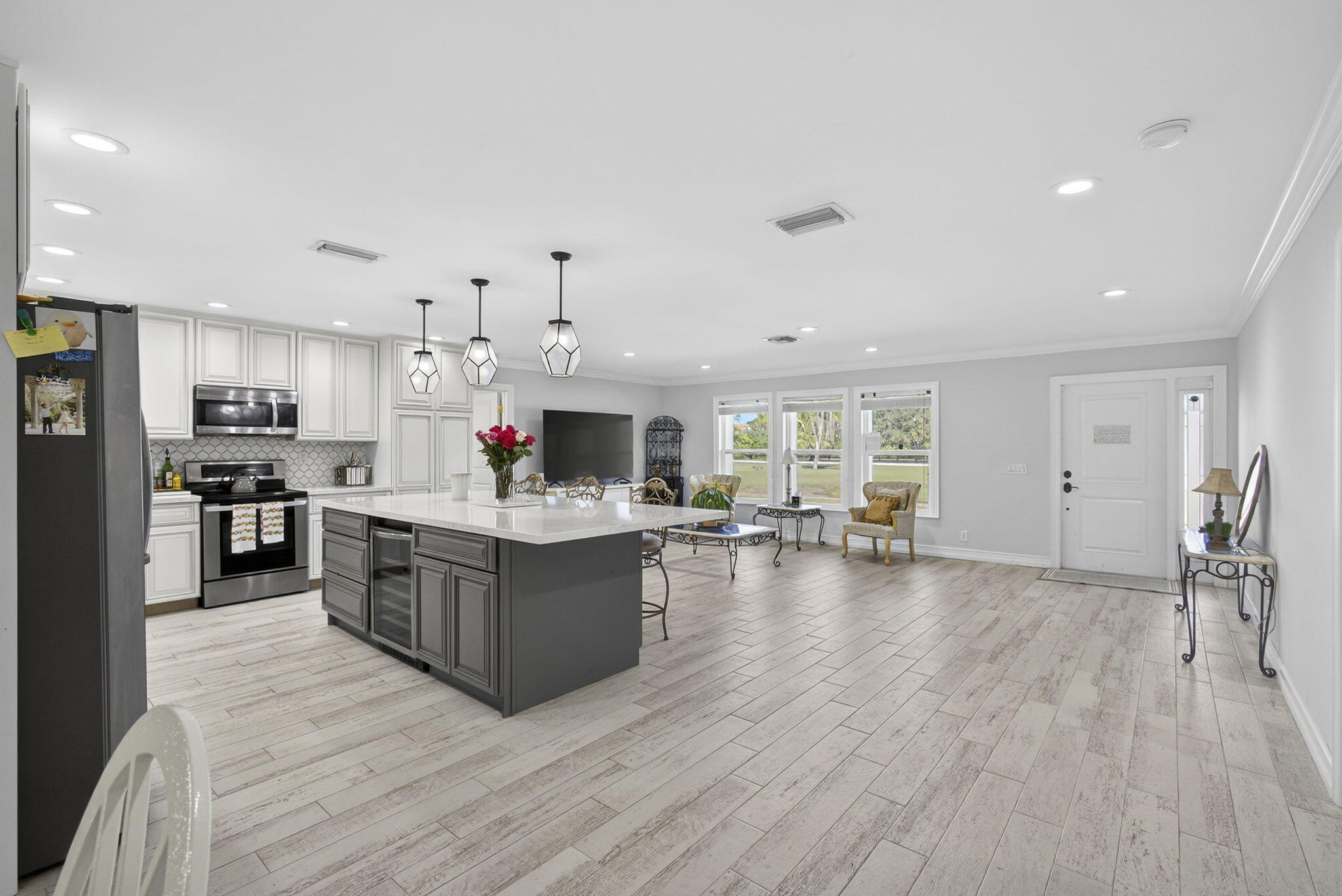16490 Rustic Road Wellington, FL 33470 - Photo 43 of 81 a large kitchen with stainless steel appliances granite countertop a large center island and a wooden floors
